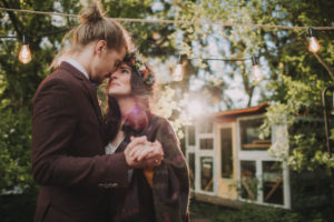 Bridal couple at alternative outdoor wedding, half profile Bridal couple at alternative outdoor wedding, half profile